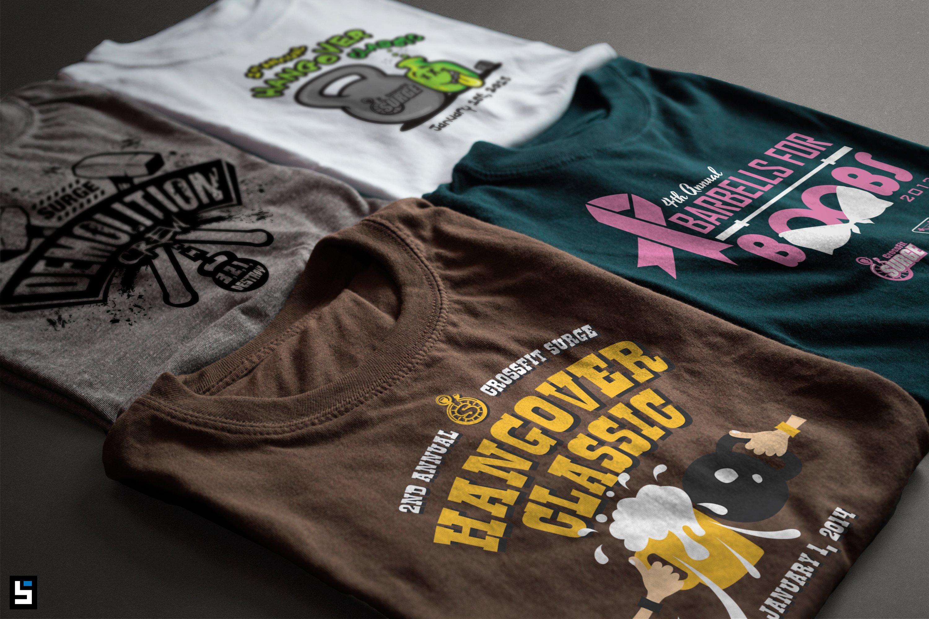 Four assorted graphic tees with various prints laid flat