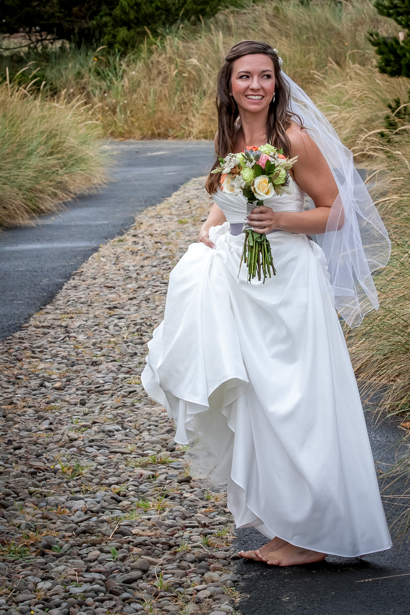 A beautiful bride standing with her flowers before the wedding.