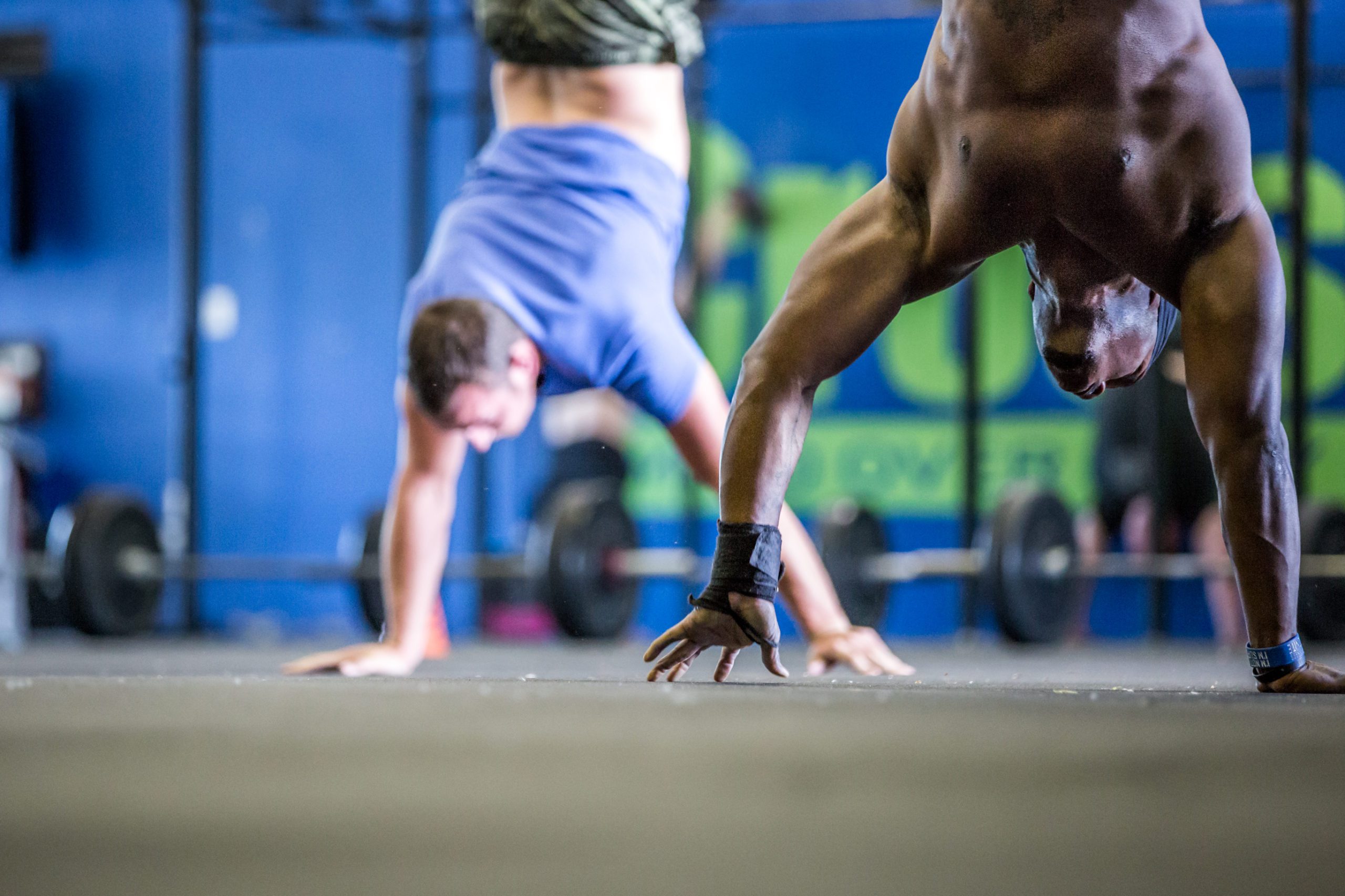 Gym Workout: Athlete Doing Handstand Walks While others perform handstand Push-Ups