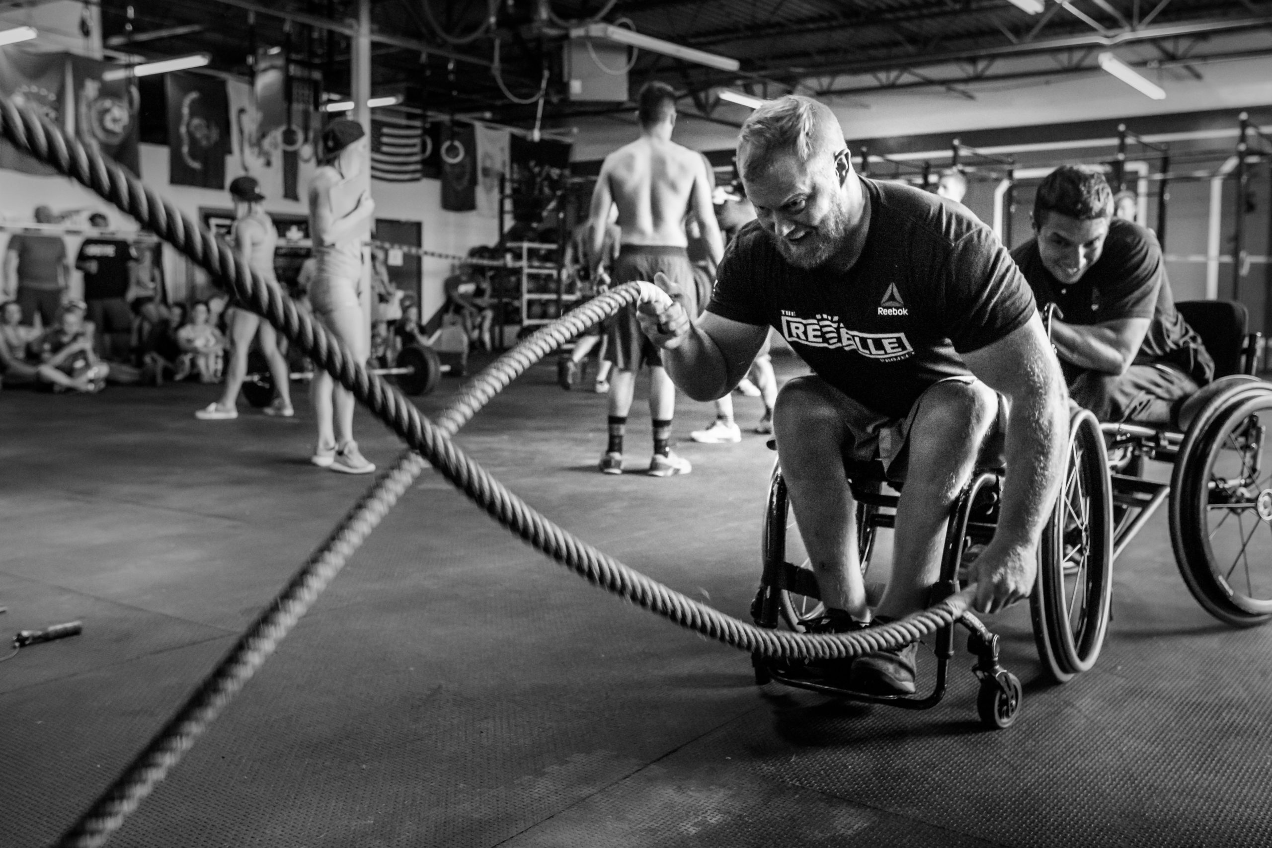 Adaptive Fitness: Wheelchair Athlete Doing Rope Exercise in Gym