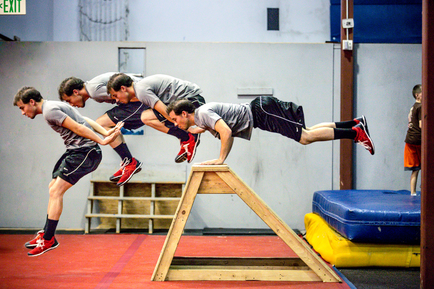 Composite image of an athlete performing a parkour vault over an obstacle