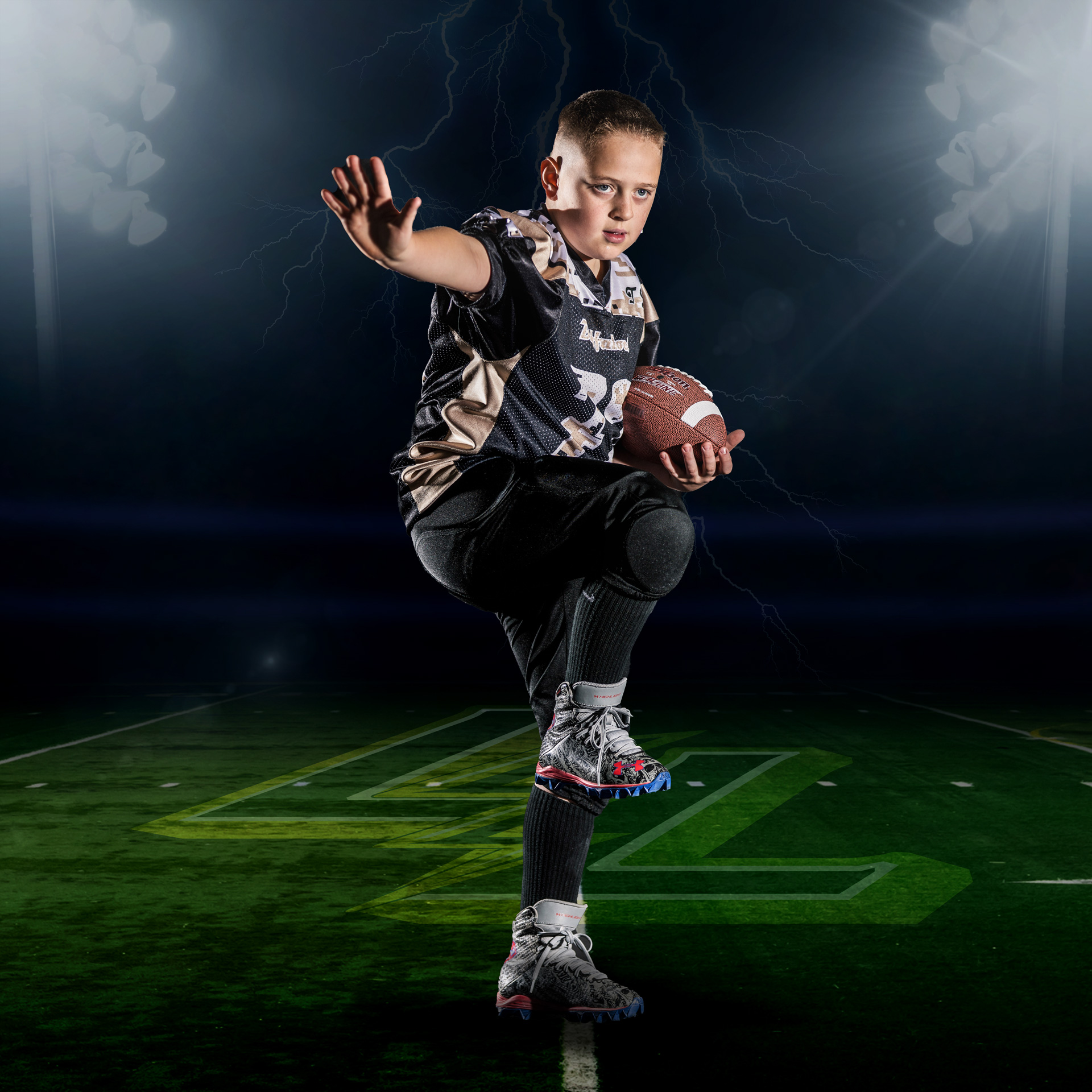 Boy in Camo Jersey Holding Football With Lightning Graphics on Dark Field