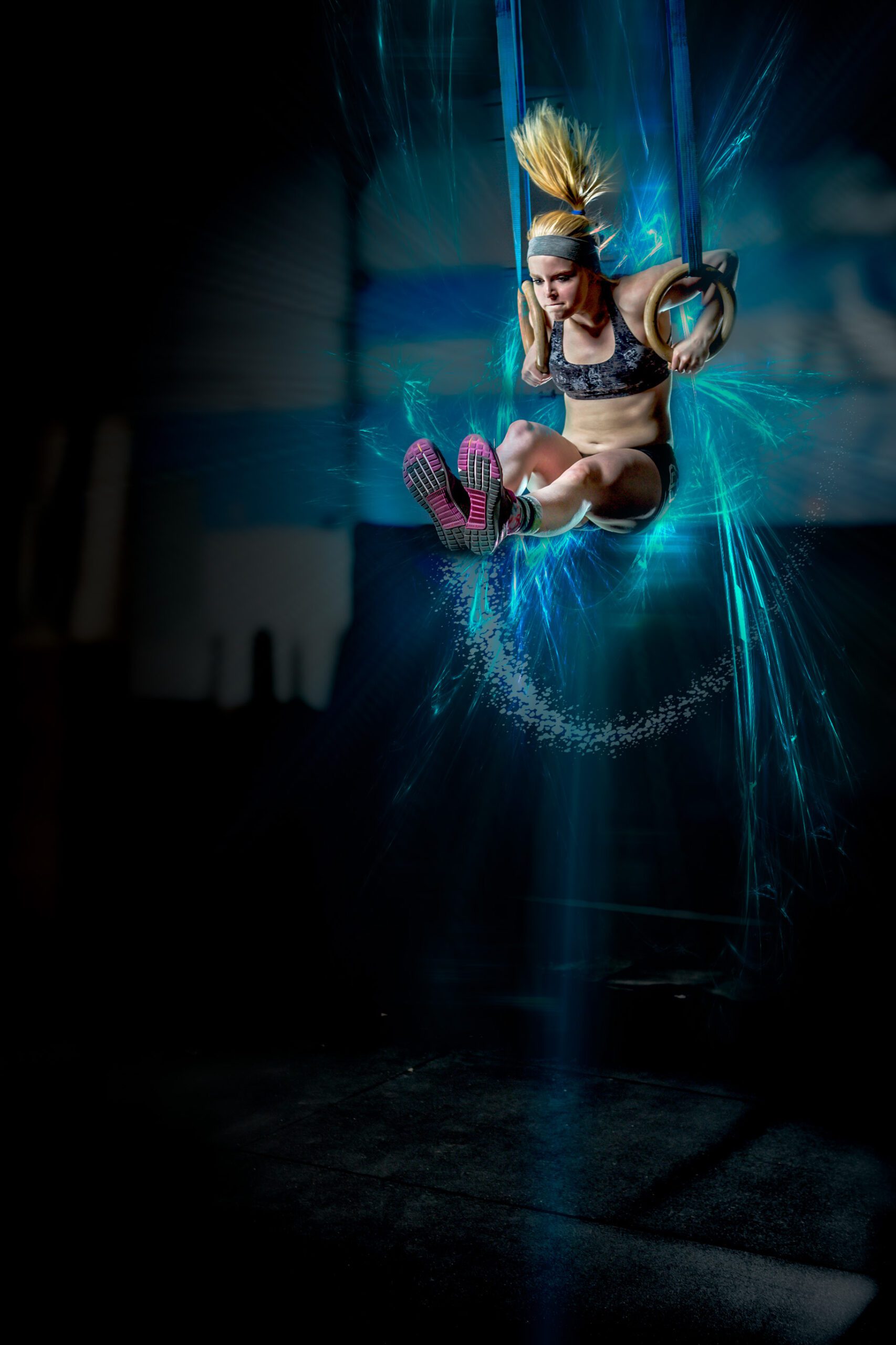 Athlete on Gymnastic Rings With Blue Light Trails