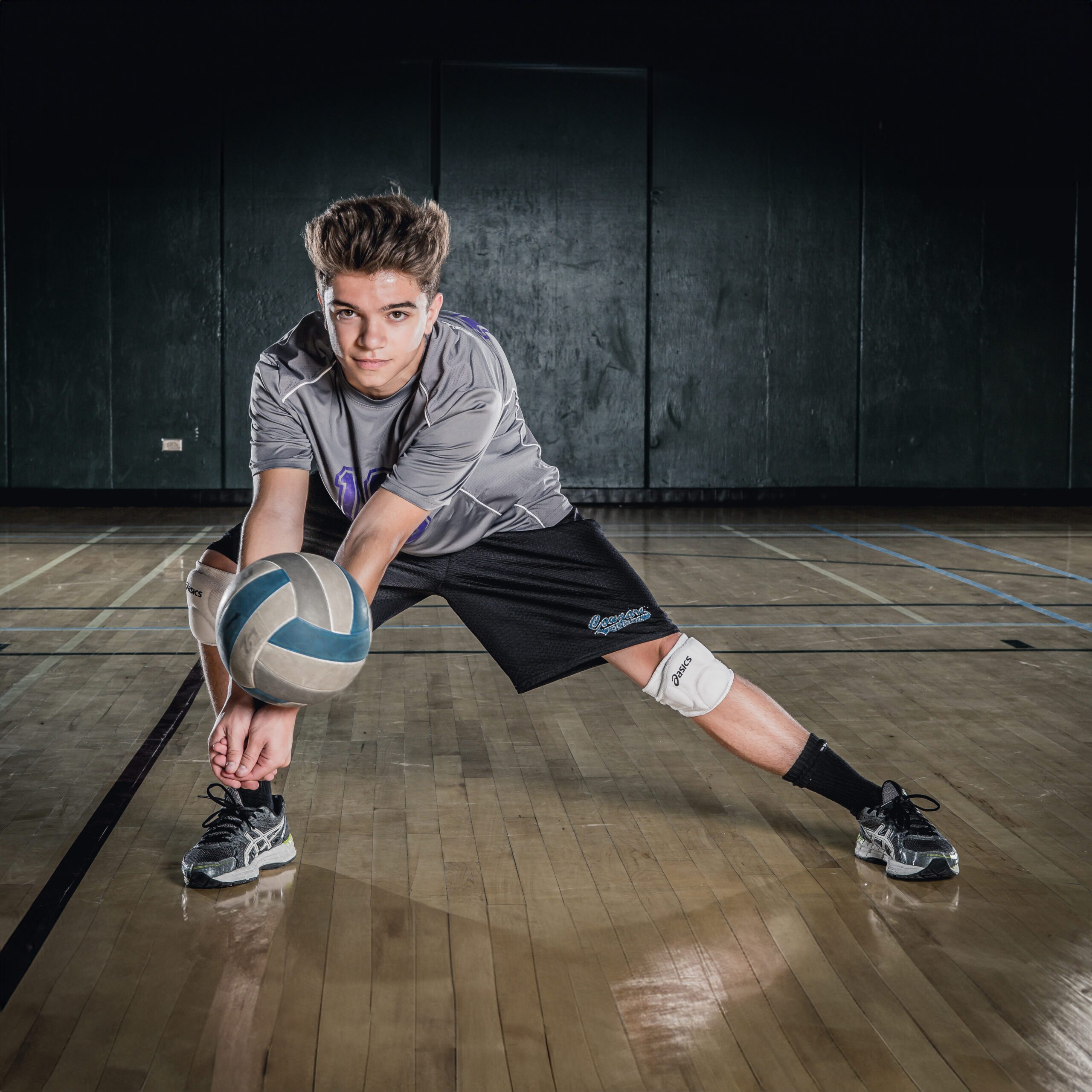 Young Male Athlete in Volleyball Gear Ready to Serve