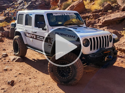 Modified Jeep 4x4 with a video play icon over it.